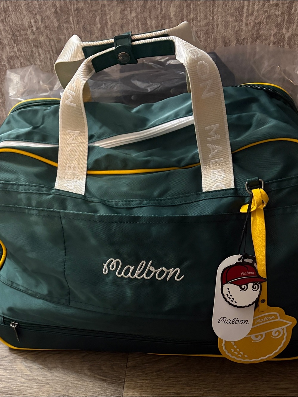 MALBON Green and gold duffel/weekender travel bag.